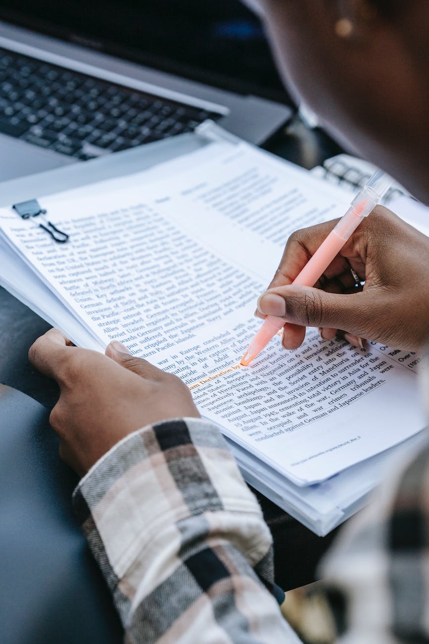 crop faceless black person highlighting words in text